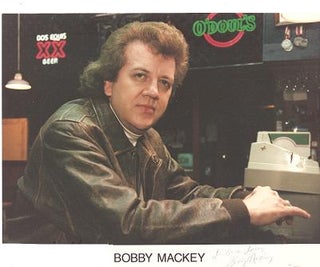 Item #034617 SIGNED, PROFESSIONAL PHOTOGRAPH OF BOBBY MACKEY:; American country entertainer,...