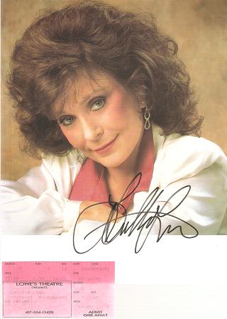 Item #035275 SIGNED, PROFESSIONAL PHOTOGRAPH OF LORETTA LYNN:; With a ticket stub from her July 14, 1991 concert at a Lowe's Theatre in Missouri. Loretta Lynn.