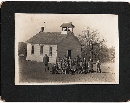 Item #040114 ORIGINAL PHOTOGRAPH OF STUDENTS AND THEIR MALE TEACHER, OUTSIDE A ONE-ROOM SCHOOLHOUSE WITH BELFRY. Oakwood Oklahoma.